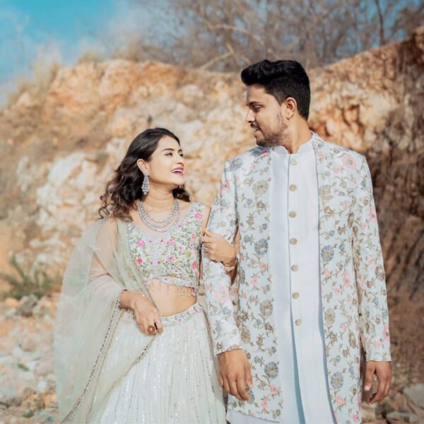 "Stylish couple outfit with coordinated Indo-western sherwani and lehenga."