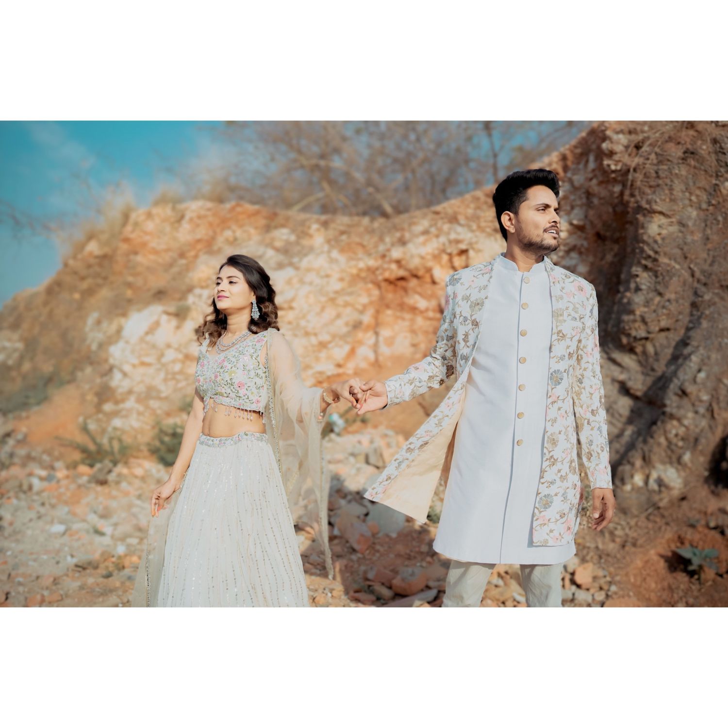 "Stylish couple outfit with coordinated Indo-western sherwani and lehenga."