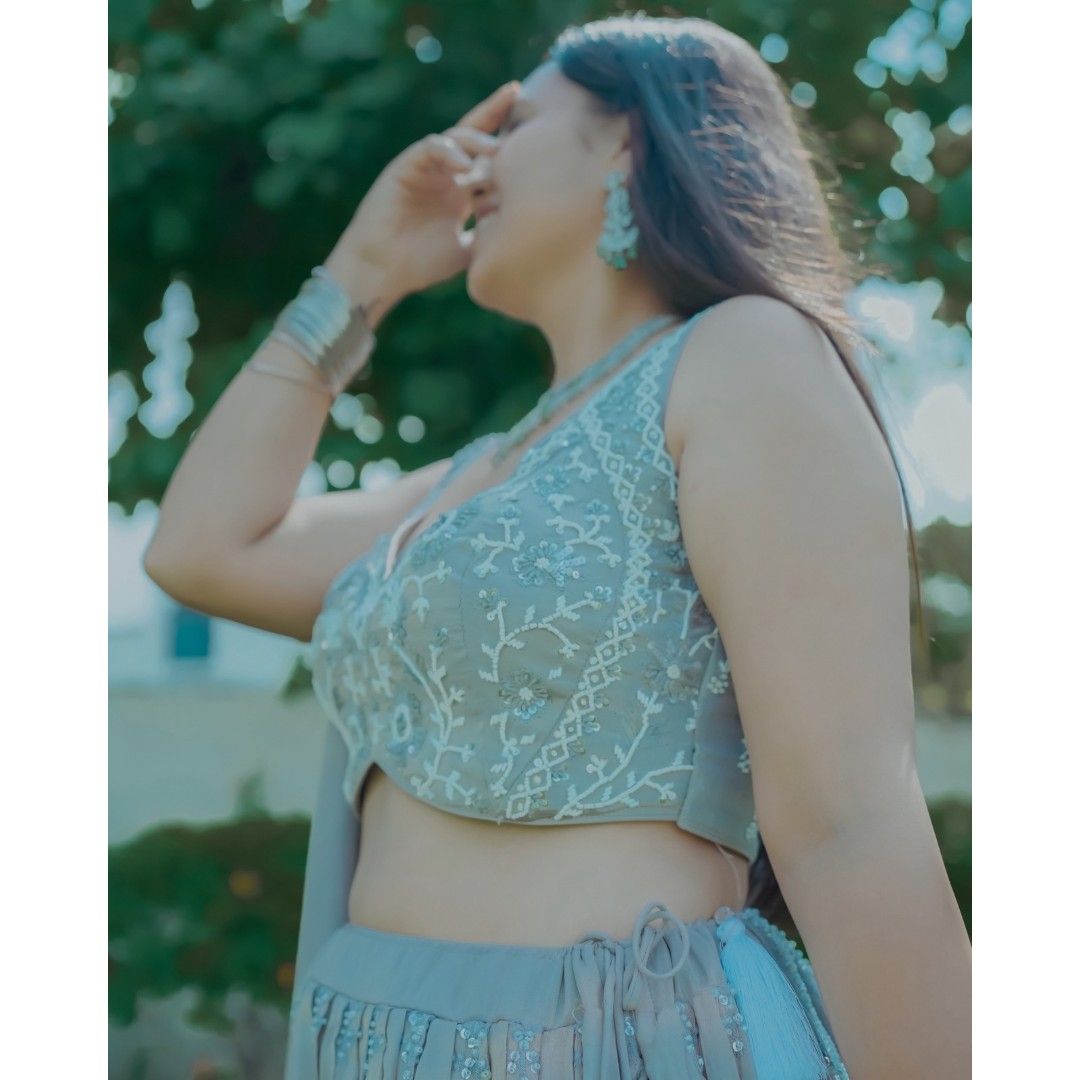 Elegant Radiant White Silver Handwork Crop Top Lehenga on display.