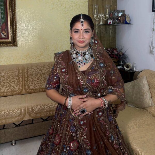Bride wearing elegant brown bridal lehenga on rent with traditional embroidery, available on rent at Fancyano Udaipur