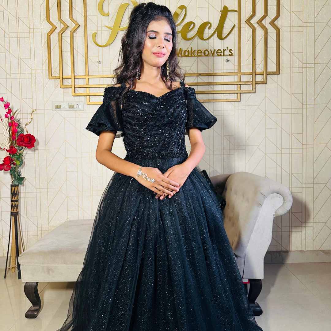 Girl wearing elegant black ball gown at night garden event with lights