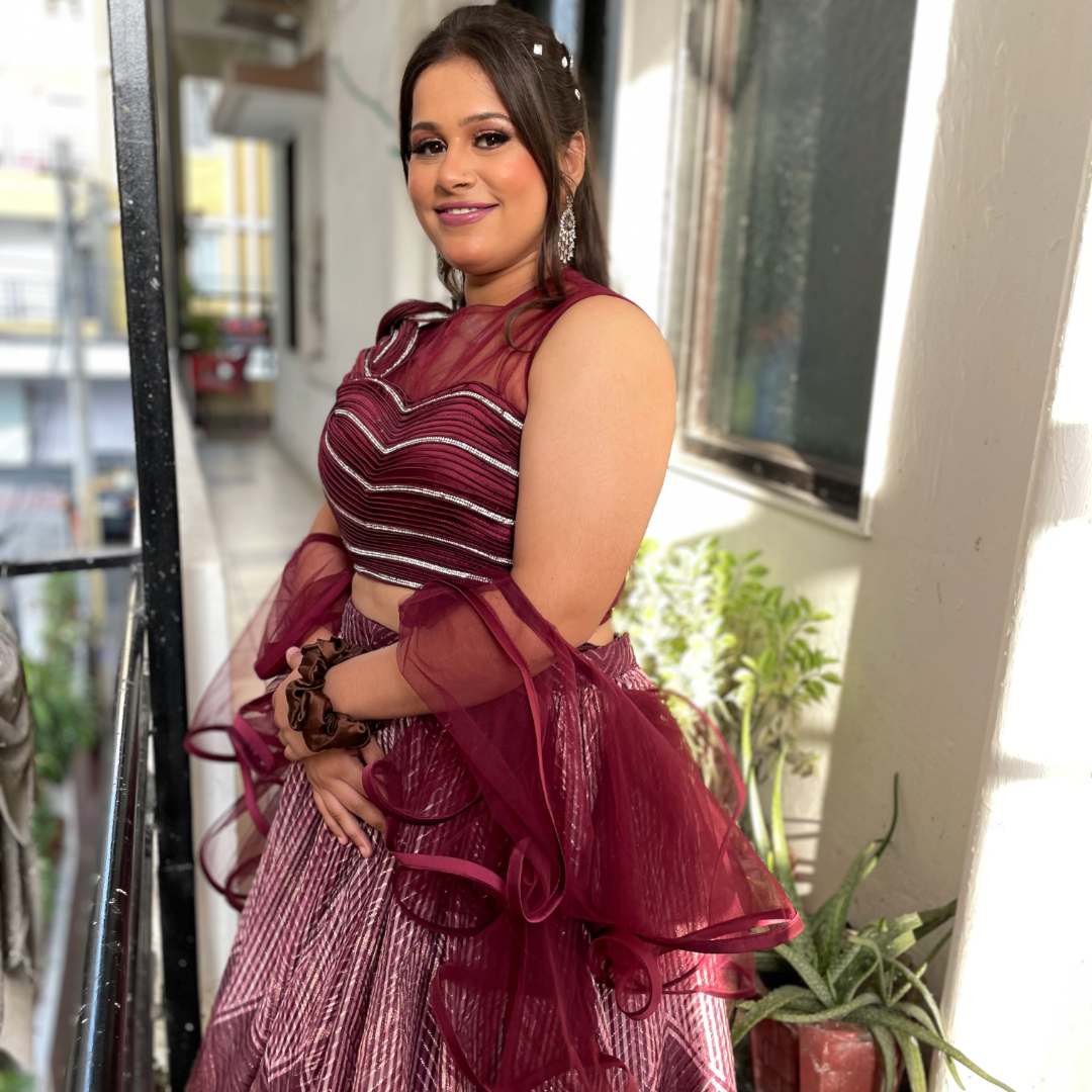 Bride twirling in wine designer crop top fancy lehenga