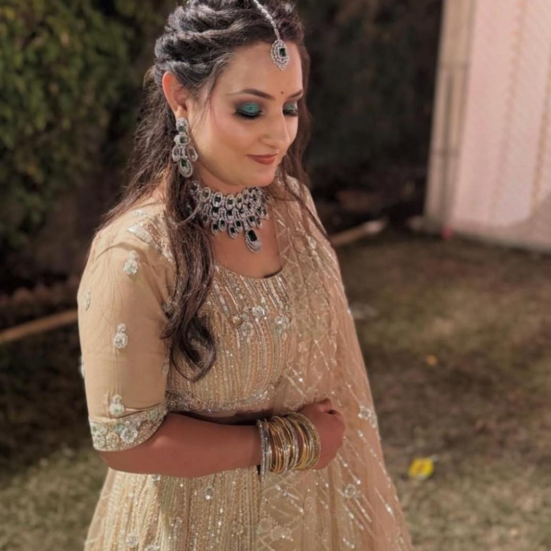 Woman wearing Golden Designer Lehenga Rent in Udaipur