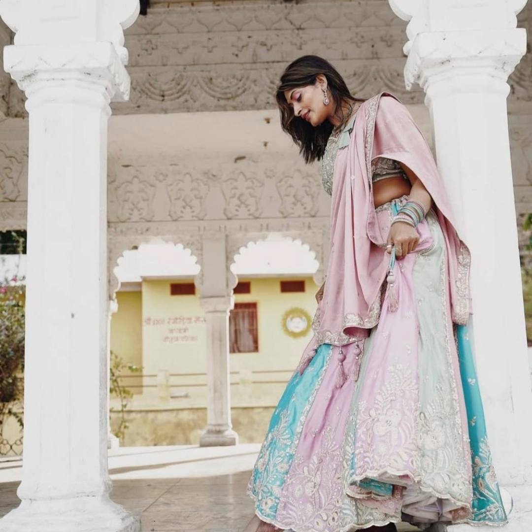 Woman in multicolour lehenga for rent from Fancyano Udaipur