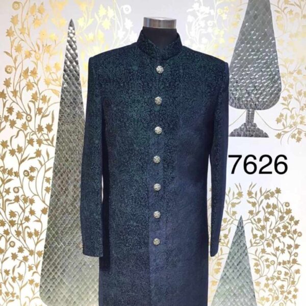 Model wearing Fancyano Dark Green Textured Achkan for Men, with subtle patterned fabric and decorative buttons.