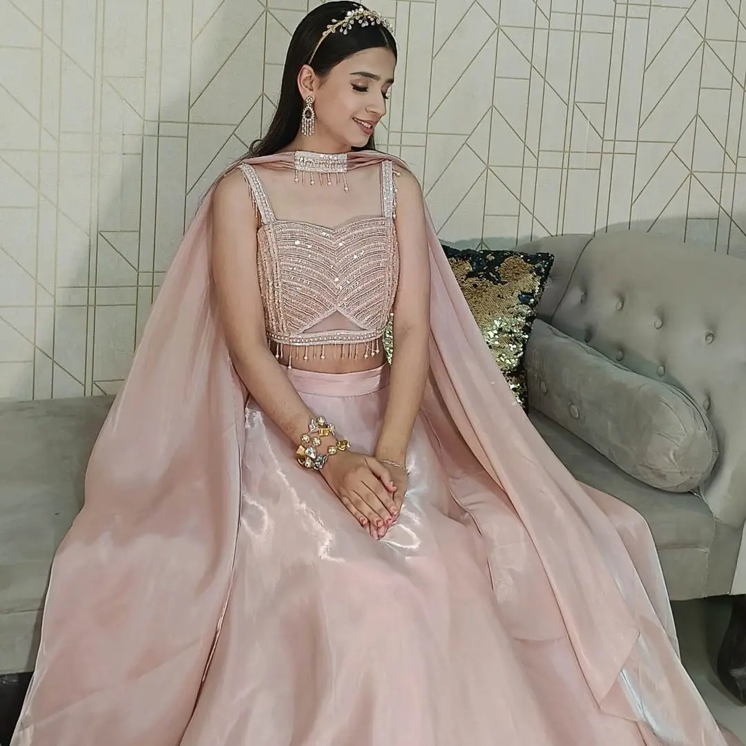 Indo Western Lehenga for Bridesmaids in pastel pink with cape dupatta, styled for modern wedding celebrations.