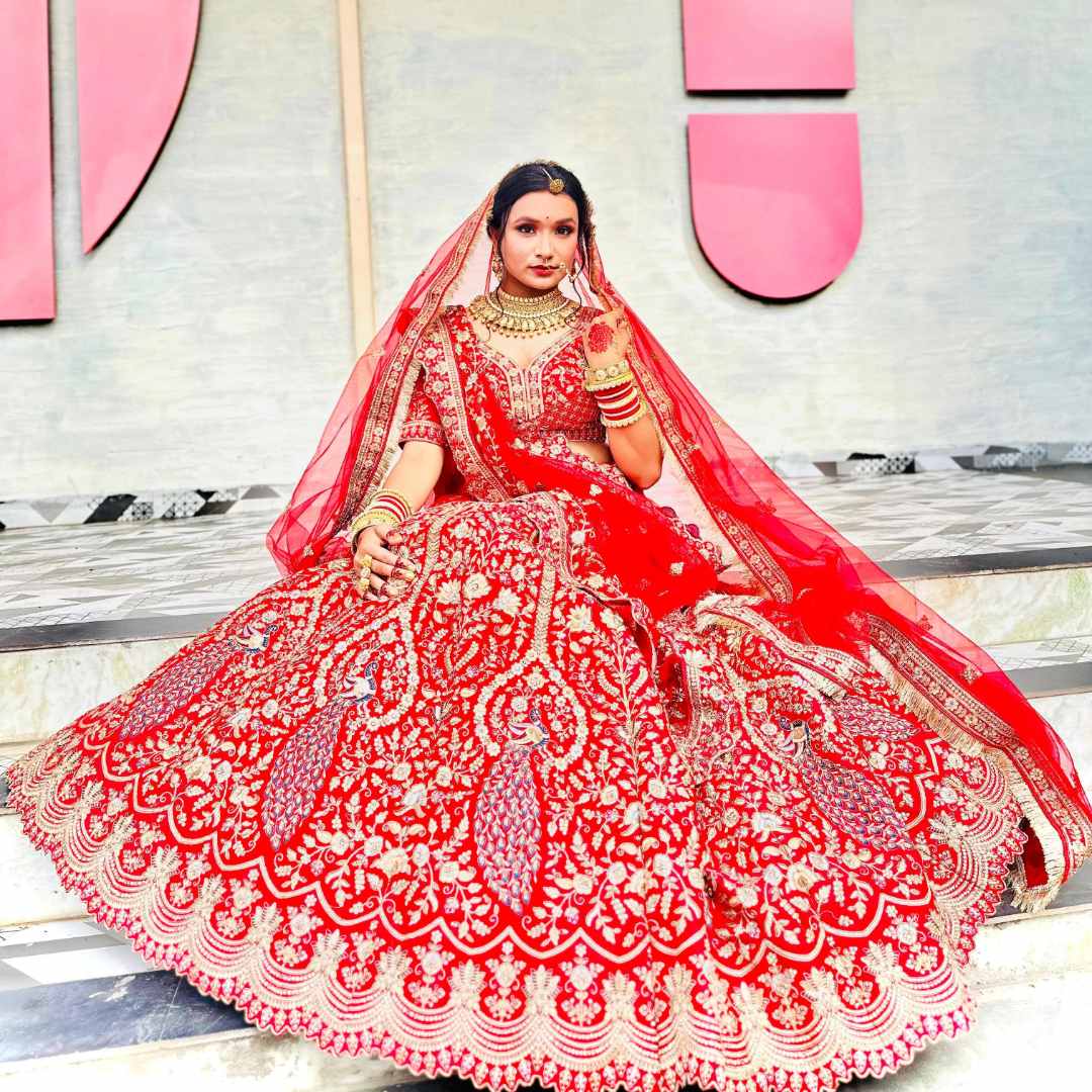 Bride wearing a stunning Blood Red Mor Designer Lehenga with intricate handwork and royal flair