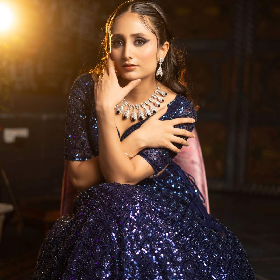 Model twirling in Sparkling Designer Lehenga with sequins and shimmer