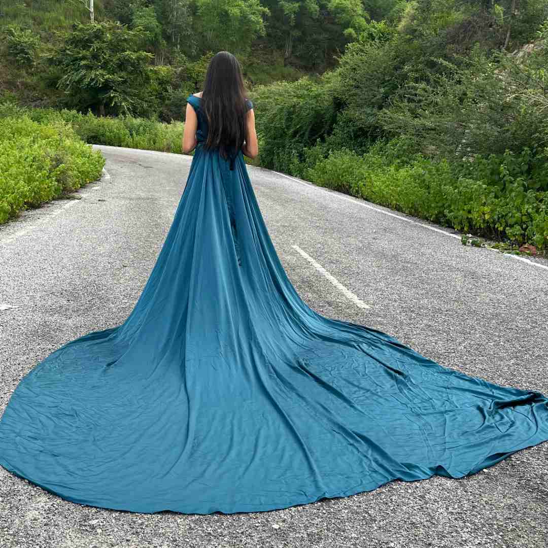 Woman in elegant green satin trail gown on rent for pre-wedding shoot