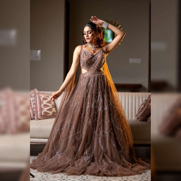 Model wearing regal brown bridal gown on hire in Udaipur