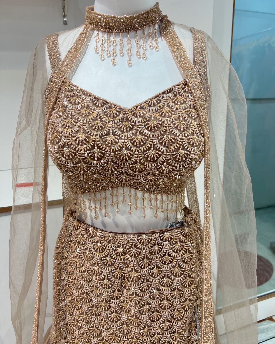 Elegant golden fish lehenga rental in Udaipur for bridal reception and wedding celebrations