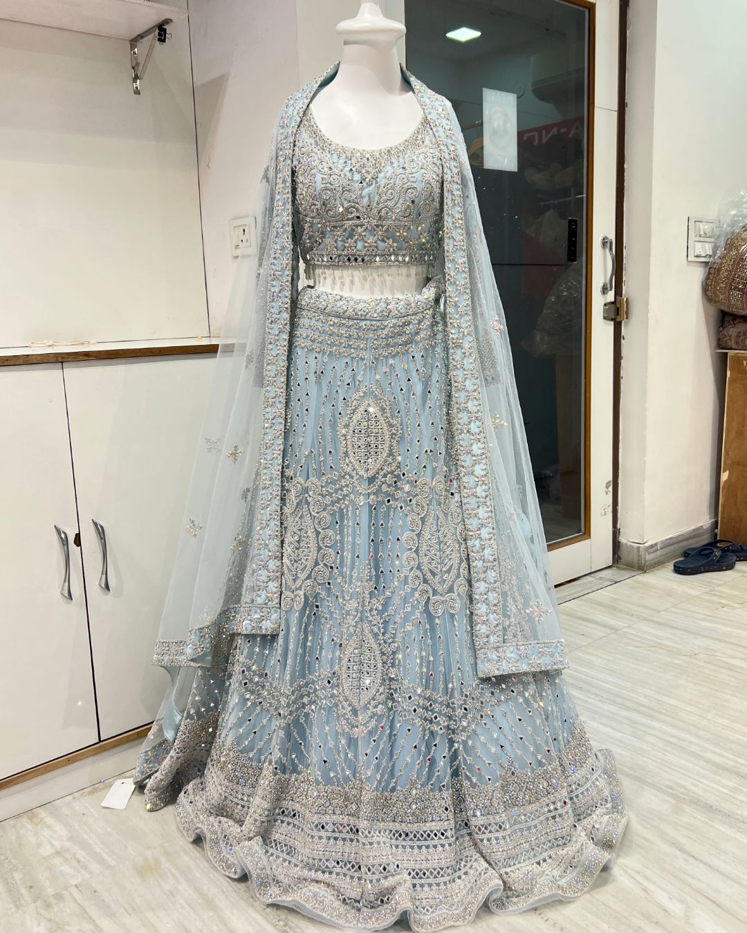 Stylish blue mirror bridal lehenga rental in Udaipur for wedding and bridal celebrations